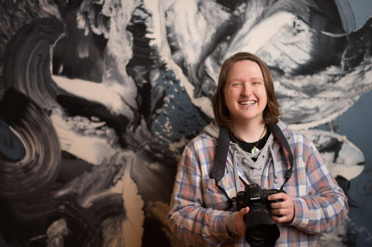 student standing in gallery smiling